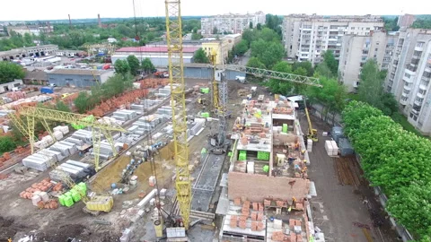 Aerial view of a construction site, builders working on a brand new building Stock Footage 140300532