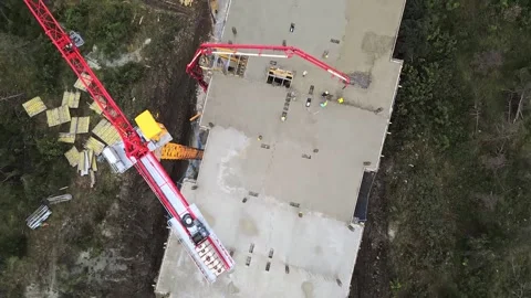 Aerial view construction site builders on rooftop lay cement build high ris.. Stock Footage 279217299