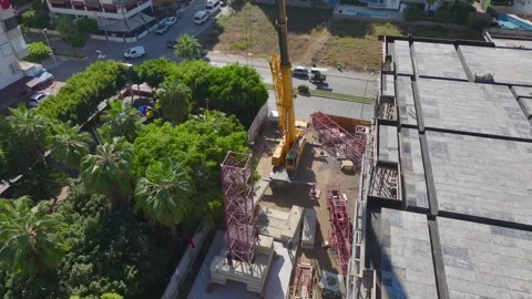 Aerial View: Construction site comes alive as workers and engineers install a Stock Footage 296017974