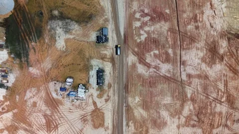 Aerial view of construction site with dirt road and equipment Stock Footage 329365256