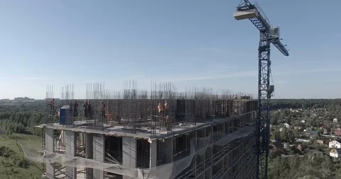 Aerial view of construction site located near small river with spinning cranes Stock Footage 105080208