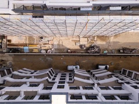 Aerial view of a construction site next to a finished modern building with Stock Photos