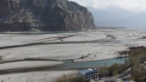 Aerial view of a construction site in a remote valley in Pakistan, surrounded by 스톡 동영상 317957975