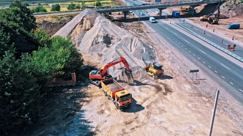 Aerial view of a construction site by the road in sunny day Stock Footage 140300433