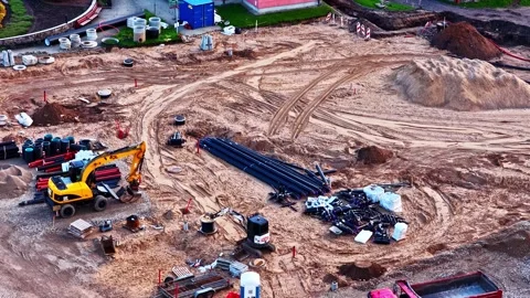 Aerial view of a construction site showing an excavator and a dump truck Stock Footage 340860967