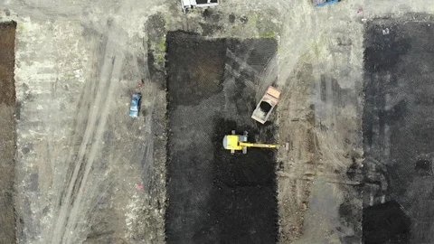 Aerial view of the construction site. Special machinery digs a pit. Stock Footage 111529979