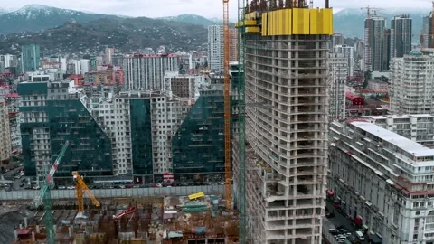 Aerial view of construction site with tower cranes working and building new Stock Footage 279642194