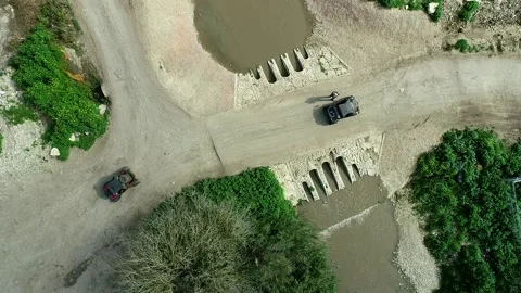 Aerial view of construction site with water crossing and vehicle Stock Footage 341592134