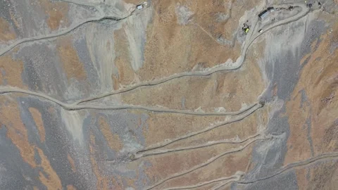 Aerial view of construction site with winding roads and machinery in motion Video stock 319435604