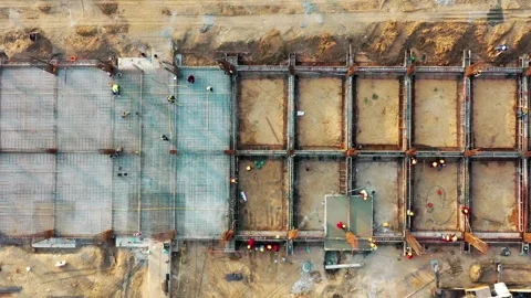 Aerial view of construction site with workers assembling steel rebar Stock Footage 312432990