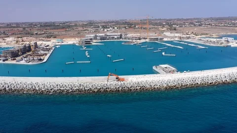 Aerial view of the construction of the stone defense of the marina Stock Footage 120035403