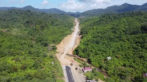 Aerial view of the construction of the toll road from Tanah Bumbu to Banjar.. Stock Footage 248341145