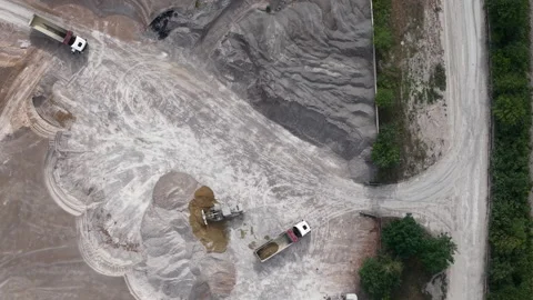 Aerial view of construction trucks and heavy machinery operating within a Stock Footage 342700730