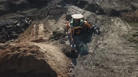 Aerial view of construction work with two diggers moving dirt Stock Footage 160115963