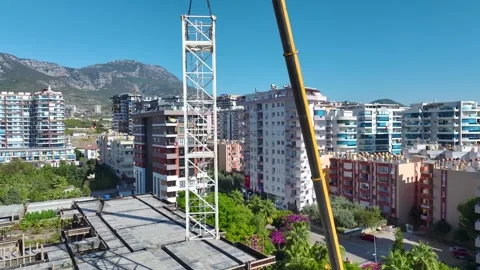 Aerial View: Construction workers and engineers collaborate to install a crane Stock-Footage 296019721