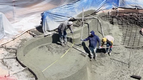 Aerial view of construction workers building residential swimming pool in Stock Footage 333329750
