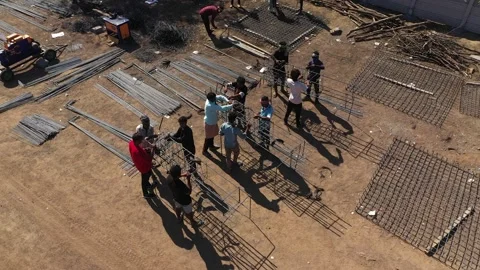 Aerial View of Construction Workers Crafting Rebar Reinforcement for Building Vídeos de archivo 337790173