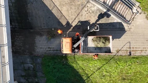 Aerial View of Construction Workers Loading Debris into Truck Stock Footage 301675633