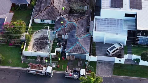 Aerial View of Construction Workers Performing Roof Restoration Stockbeeldmateriaal 337690897