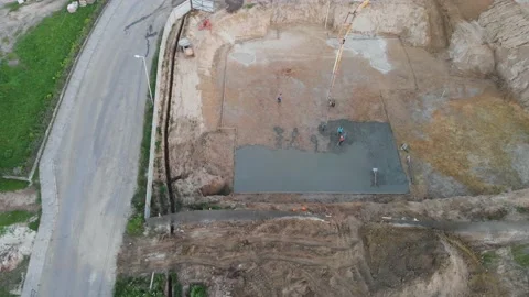 Aerial view construction workers pouring concrete at construction site basis. Stock Footage 147496656