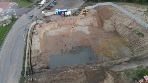Aerial view construction workers pouring concrete at construction site basis. Stock Footage 147496734