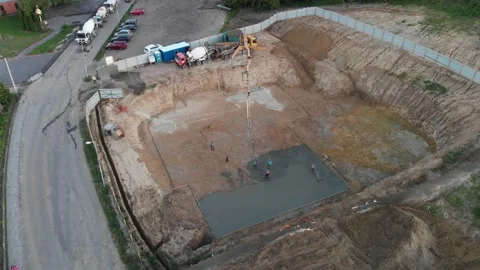 Aerial view construction workers pouring concrete at construction site basis. Stock Footage 147496796