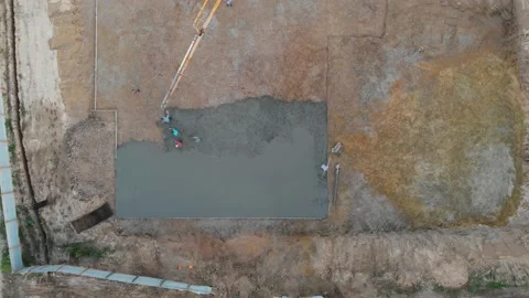 Aerial view construction workers pouring concrete at construction site basis. Stock Footage 147496823