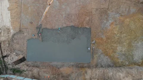 Aerial view construction workers pouring concrete at construction site basis. Stock Footage 147496871