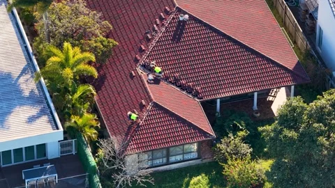 Aerial View of Construction Workers Repairing Terracotta Tile Roof Stock Footage 341842545