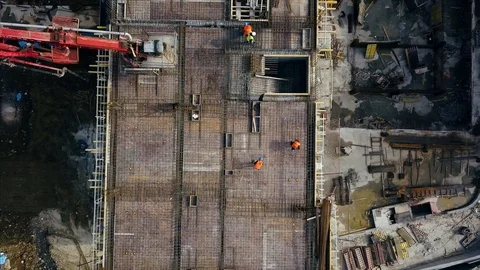 Aerial view of construction workers work on top of the building Stock Footage 98528008