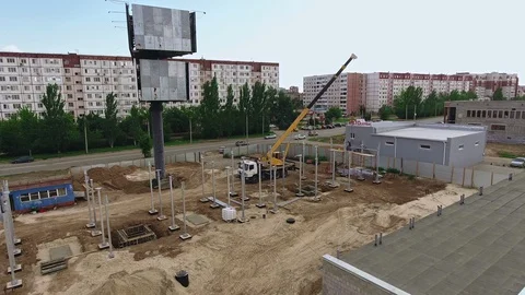 Aerial view of construction workers work at construction site Stock Footage 129950815