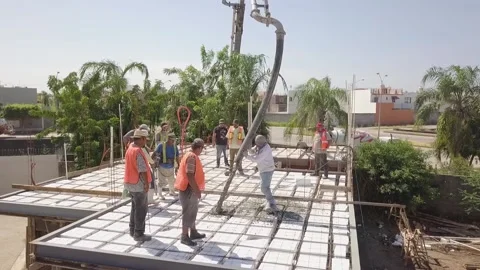Aerial view of construction workers working on the roof pouring cement to Video stock 148050517