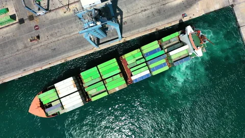 Aerial view of container ship maneuvering for docking in the port of Alicante. Stock Footage 143136681