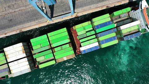 Aerial view of container ship maneuvering for docking in the port of Alicante. Stock Footage 143136684