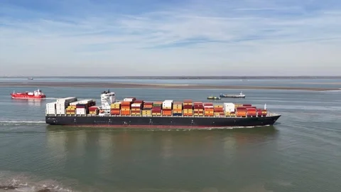 Aerial view of container ship navigating a busy waterway Stock-Footage 334579327