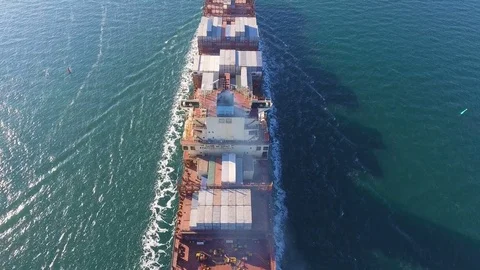 Aerial view of container ship passes through the channel goes into the ocean. Stock Footage 75460399