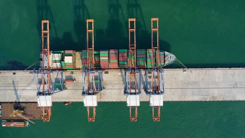 Aerial view. Container ship in pier with crane bridge carries out export and imp Stock Footage 105724410