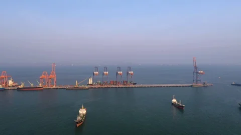 Aerial view. Container ship in pier with crane bridge carries out export and imp Stock Footage 105724712