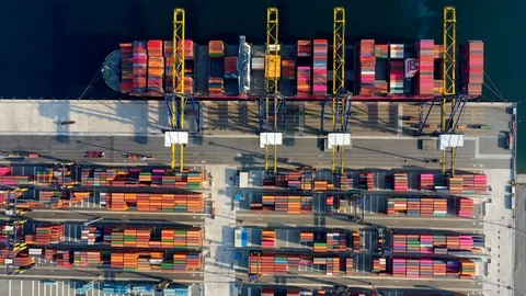 Aerial view. Container ship in pier with crane bridge carries out export and imp Stock Footage 107095380