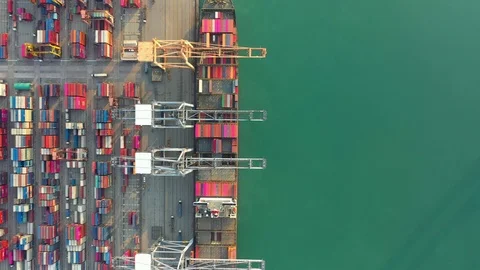 Aerial view. Container ship in pier with crane bridge carries out export  Видео 124909556