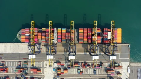 Aerial view. Container ship in pier with crane bridge carries out export  Stock Footage 125681063