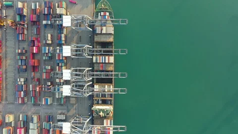 Aerial view. Container ship in pier with crane bridge carries out export  Video stock 125682816