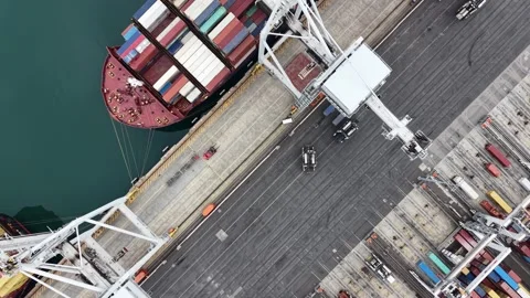 Aerial view of container ship unloading at port terminal Stock Footage 337811383
