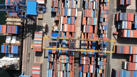 Aerial view of a container ship unloading colorful cargo containers at a Stock Photos