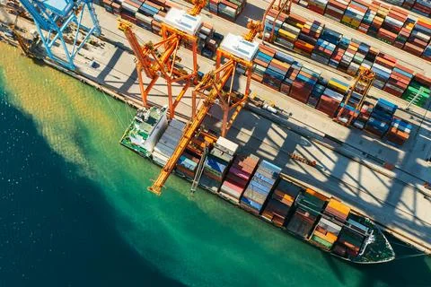 Aerial view of containers loading and unloading to the ship in the sea port Fotos Stock