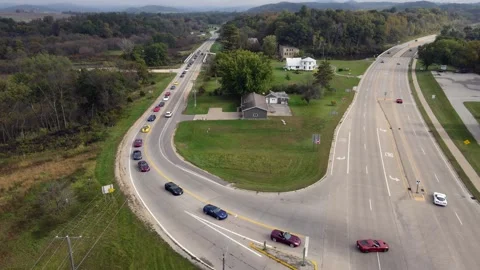 Aerial view of corvette car parade approaching interestion. Stock Footage 166136559