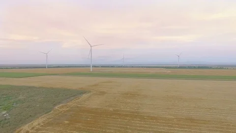 Aerial view of countryside with agricultural fields and wind turbines Stock Footage
