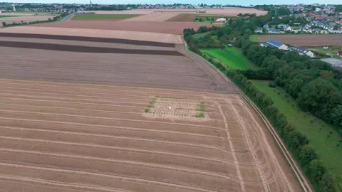 Aerial view of countryside fields and farmland with scenic horizon and treelined Stock Footage 315239484