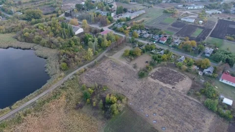 Aerial View of Countryside Fields, Lake, and Village Houses Stock Footage 317389703