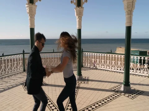 Aerial view of couple dancing salsa in the Victorian bandstand in Brighton Stock Footage 81738973